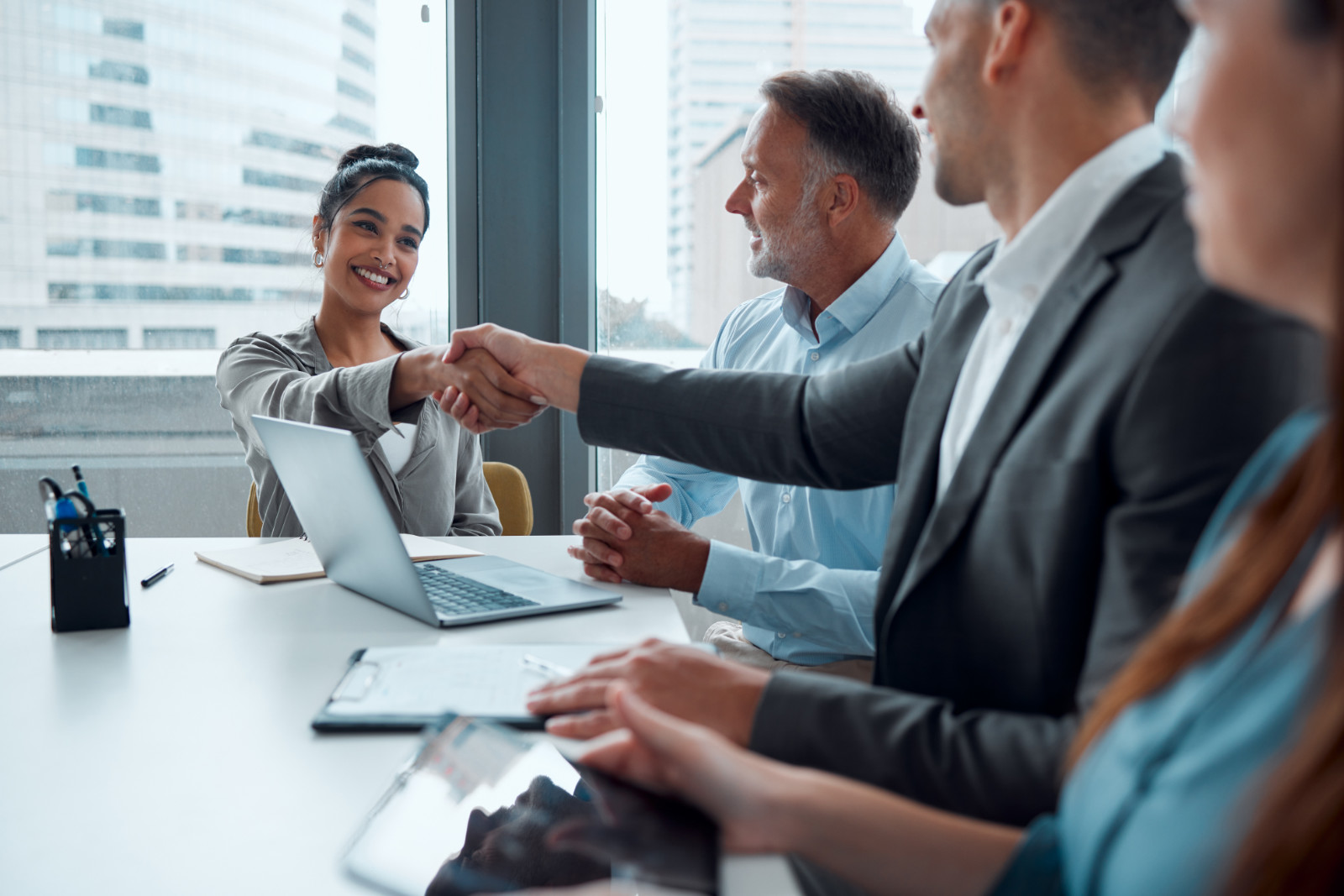 Business woman, handshake and partnership meeting for b2b interview, business meeting and thank you in office. Teamwork, corporate tech employees and shaking hands for happy onboarding conversation